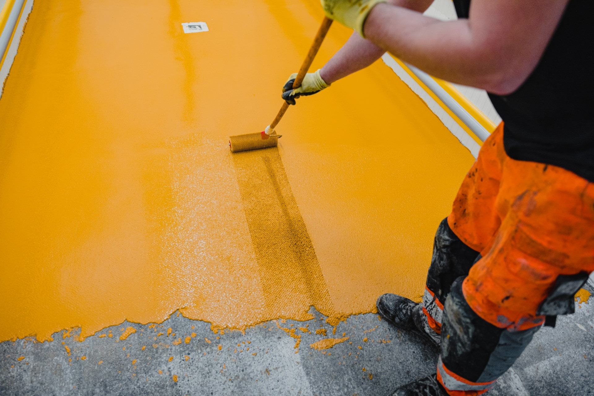 Worker applying epoxy and polyurethane flooring
